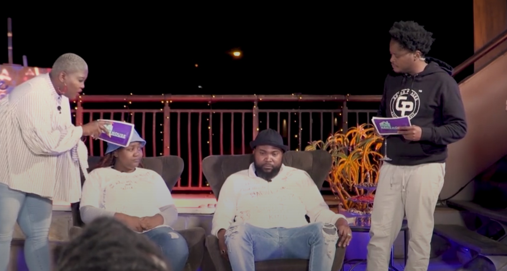 A group of four people in heated discussions in Mina Nawe House on Showmax